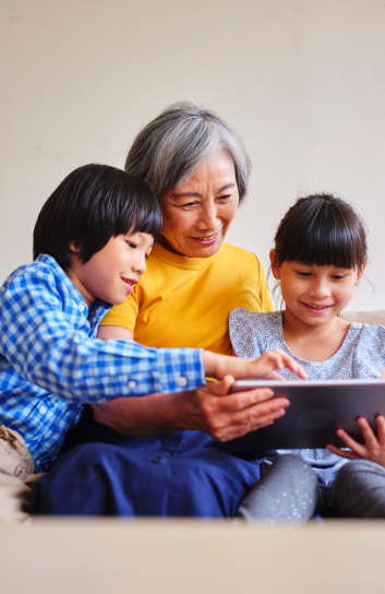 Image of grandmother with two children on tablet